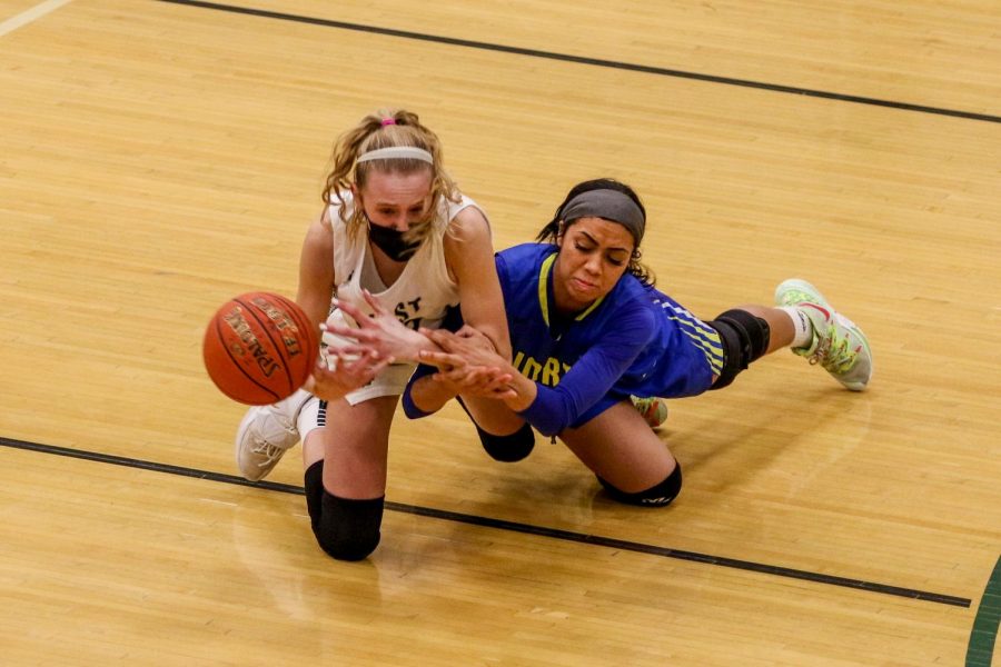 Audrey Koch '21 fights for a loose ball against Davenport North during the substate final game on Feb. 23.