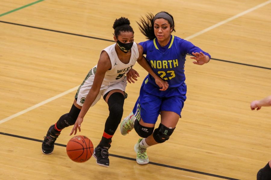 Emma Ingersoll-Weng '22 drives past her defender against Davenport North during the substate final game on Feb. 23.