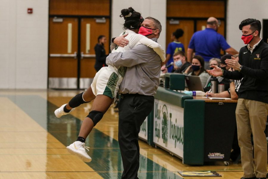 Matayia Tellis '21 hugs head coach BJ Mayer with seconds left in the substate final game on Feb. 23 against Davenport North.