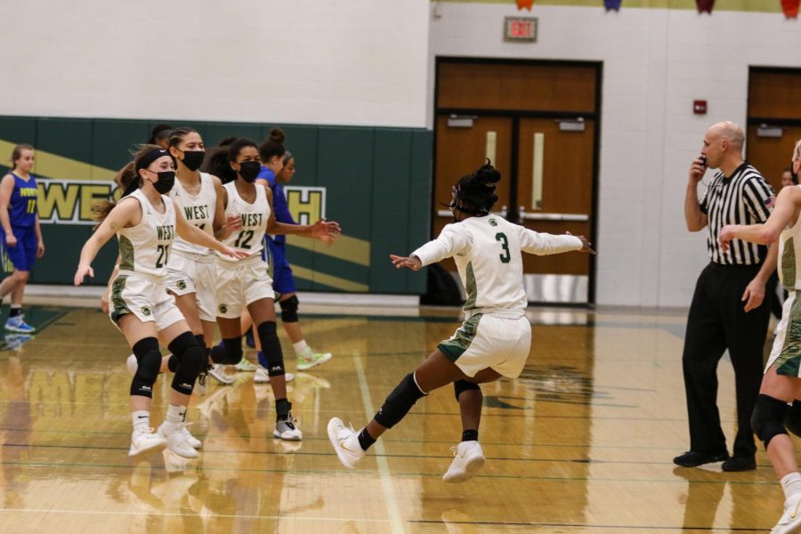 Matayia Tellis '21 runs to celebrate with her teammates after beating Davenport North and advancing to the state quarterfinals on Feb. 23.