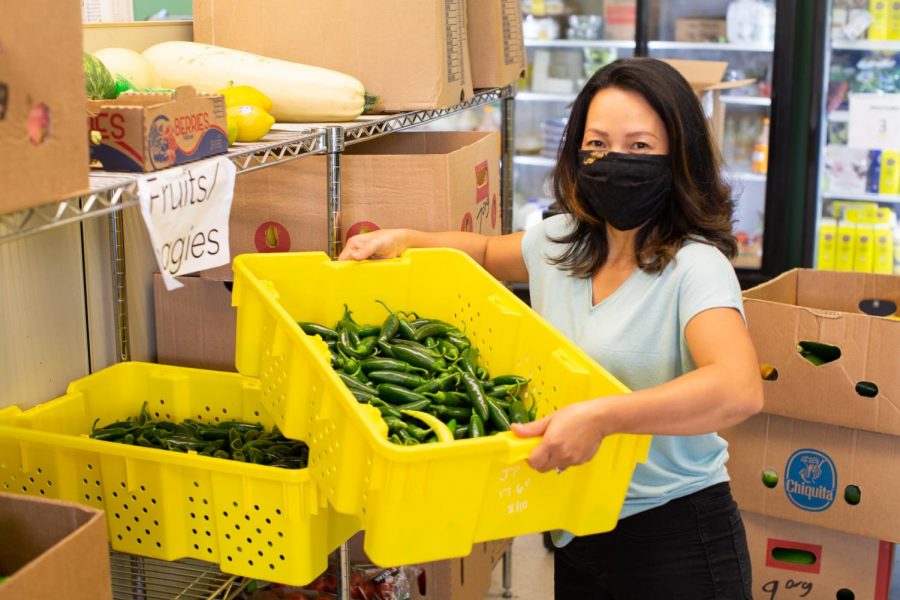 Hai Huynh, the Community Projects Coordinator for the Coralville Food Pantry, works with fruits and vegetables. 