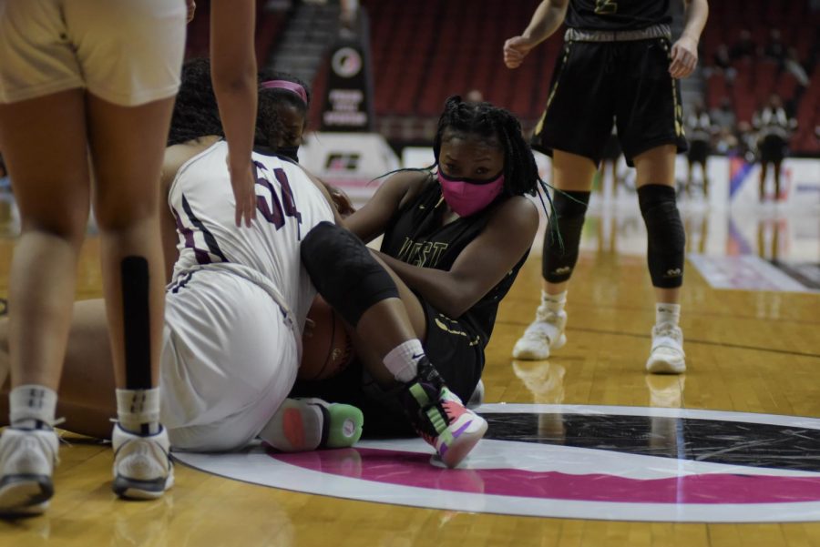 Melae Lacy 24 fights for a loose ball against Waterloo West March 1.