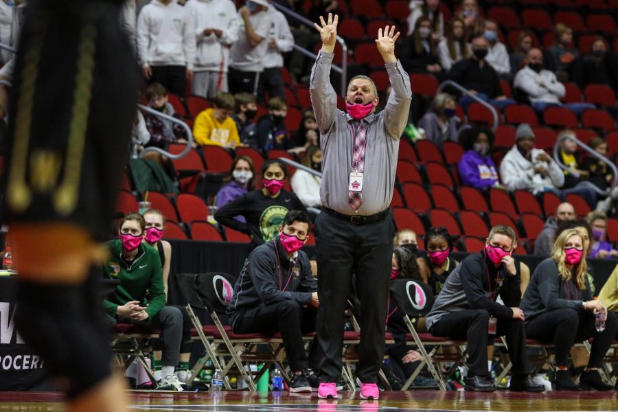 Head coach BJ Mayer calls out a play from the bench during the state semifinal game against Johnston on March 4.