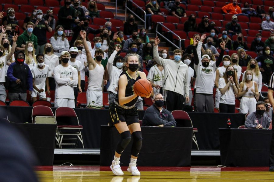 Lucy Wolf '24 squares up to shoot a three during the state semifinal game against Johnston on March 4.