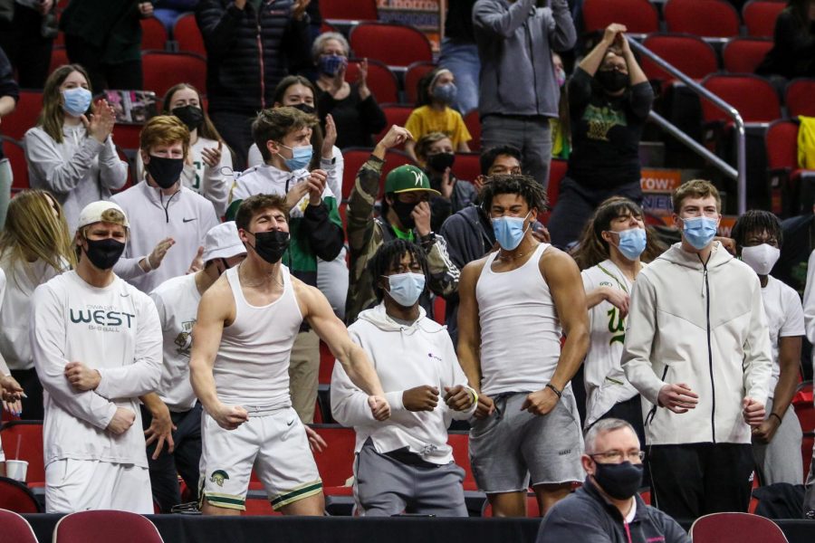 The student section celebrates an Audrey Koch '21 and-one during the state semifinal game against Johnston on March 4.