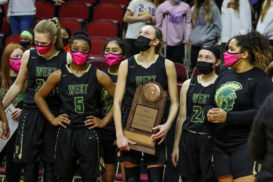 Audrey Koch '21 looks up at the scoreboard after receiving the team's state semifinalist trophy after the state semifinal game against Johnston on March 4.