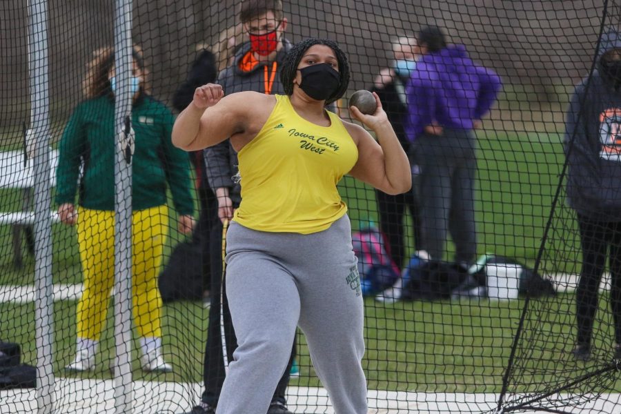 Arionnah Sonii '22 squares up to throw the shot put during the Iowa City West Invitational on March 30.