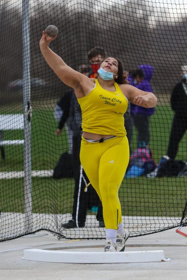 Phoebe Burt '21 throws shot put during the Iowa City West Invitational on March 30.