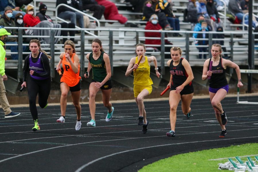 Annie Schwartz '23 fights for position at the beginning of the 4 by 800 meter relay during the Iowa City West Invitational on March 30.