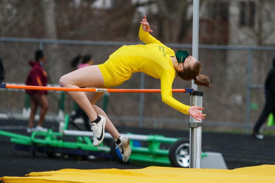 Raina Pfeifer '22 clears the bar while high jumping during the Iowa City West Invitational on March 30.