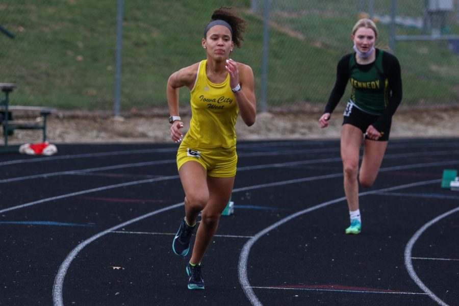 Brianna Newton '22 flys off the blocks at the start of the 400 meter race during the Iowa City West Invitational on March 30.