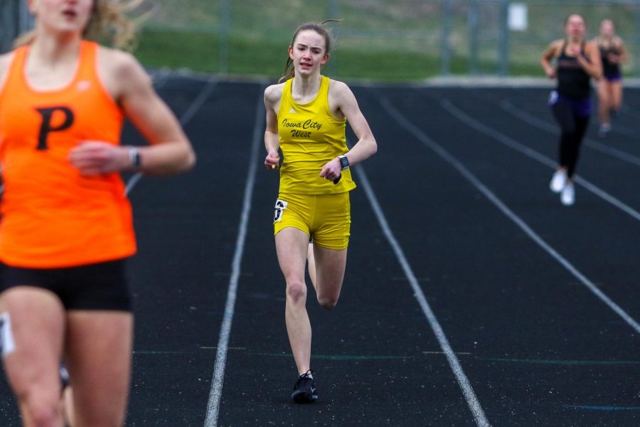 Annie Schwartz '23 finishes the 400-meter race strong during the Iowa City West Invitational on March 30.