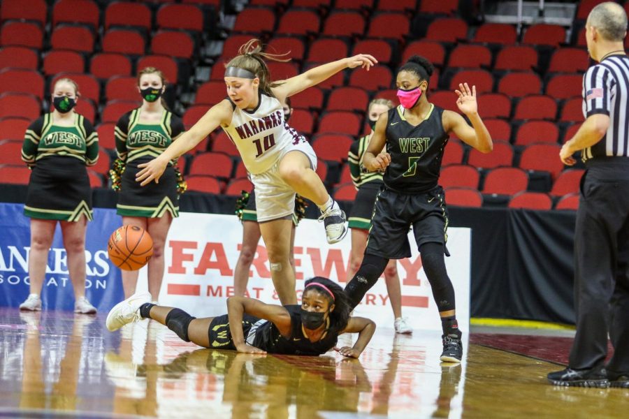 Matayia Tellis '21 and Emma Ingersoll-Weng '22 fight for a loose ball during the state quarterfinal game against Waterloo West on March 1.