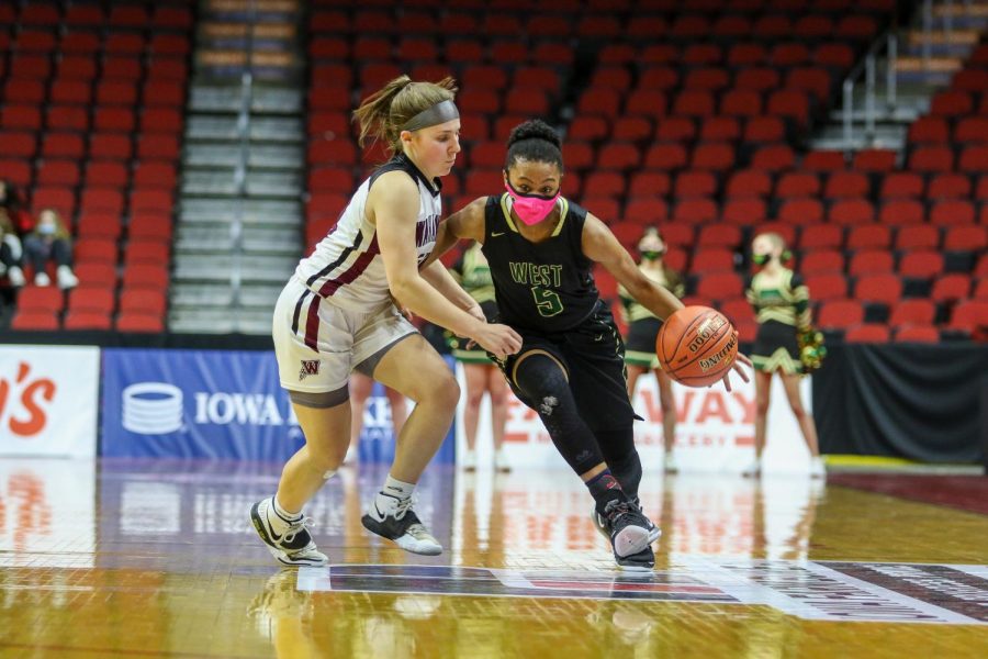 Emma Ingersoll-Weng '22 brings the ball up the floor during the state quarterfinal game against Waterloo West on March 1.