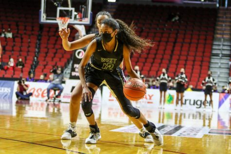 Meena Tate 23 drives into the lane during the state quarterfinal game against Waterloo West on March 1.