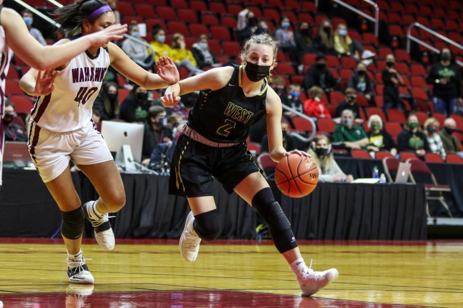 Freshman Lucy Wolf gets past her defender while driving into the lane during the state quarterfinal game against Waterloo West on March 1.