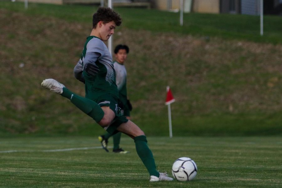 Owen Smith '21 drops the ball back to be cleared against Linn-Mar on April 20 at Ed Barker Field.