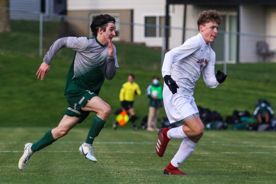 Michael Nelson '23 chases down his defender against Linn-Mar on April 20 at Ed Barker Field.