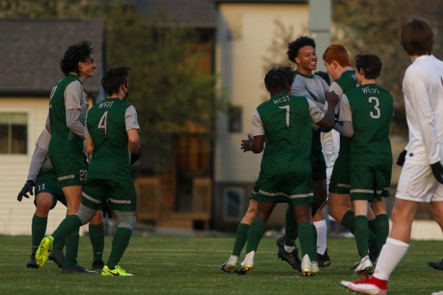 Kolby Godbolt '21 and Charlie Millier '21 celebrate a goal against Linn-Mar on April 20 at Ed Barker Field.