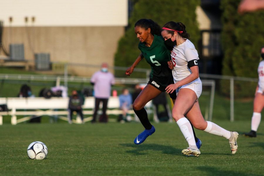 Meena Tate '23 chases down a loose ball against City High at Ed Barker Field on April 22.