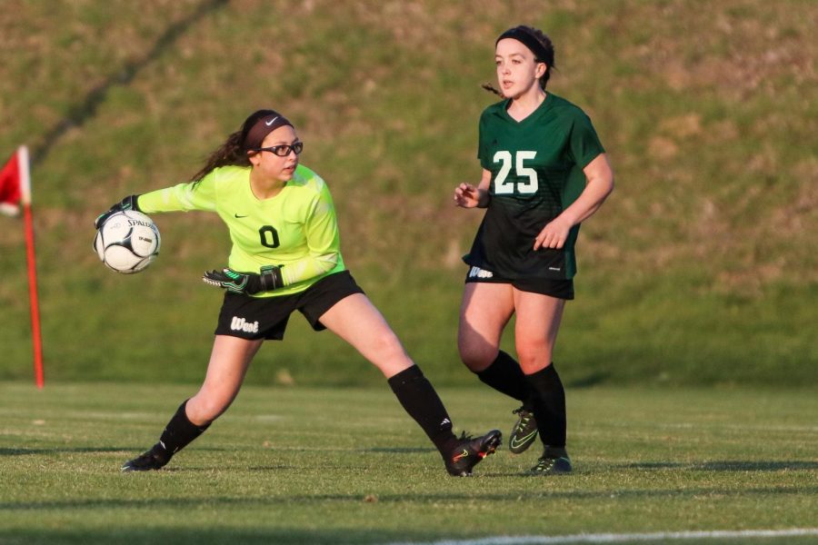 Goalkeeper Julia Bernat '21 looks to throw the ball ahead to one of her teammates against City High at Ed Barker Field on April 22.