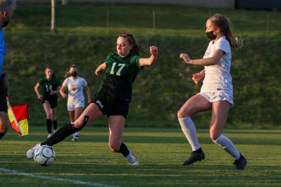 Grace Curran '21 reaches to keep the ball inbounds against City High at Ed Barker Field on April 22.