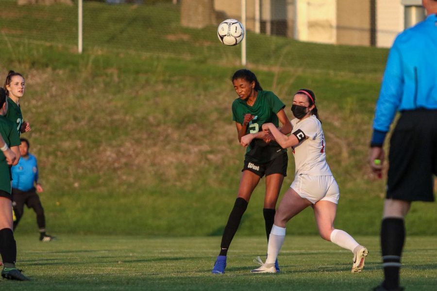 Meena Tate '22 heads the ball into the penalty box against City High at Ed Barker Field on April 22.