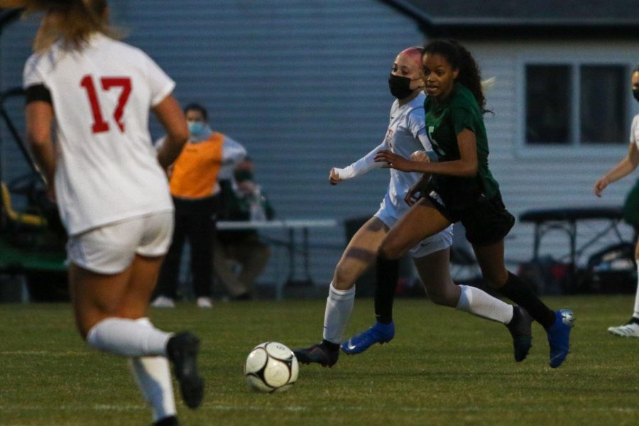 Meena Tate '23 eyes the ball on a break away against City High at Ed Barker Field on April 22.