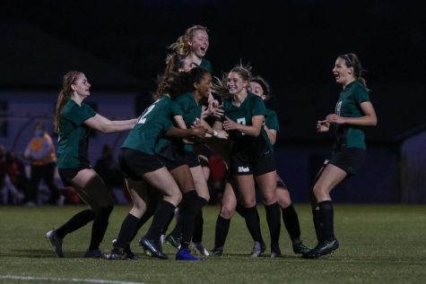 Meena Tate 23 is swarmed by her teammates as they celebrate her goal to put the Trojans up 1-0 against City High at Ed Barker Field on April 22.