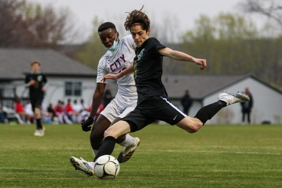 Matthew Steinbronn '21 crosses the ball into the box against City High at Ed Barker Field on April 23. 