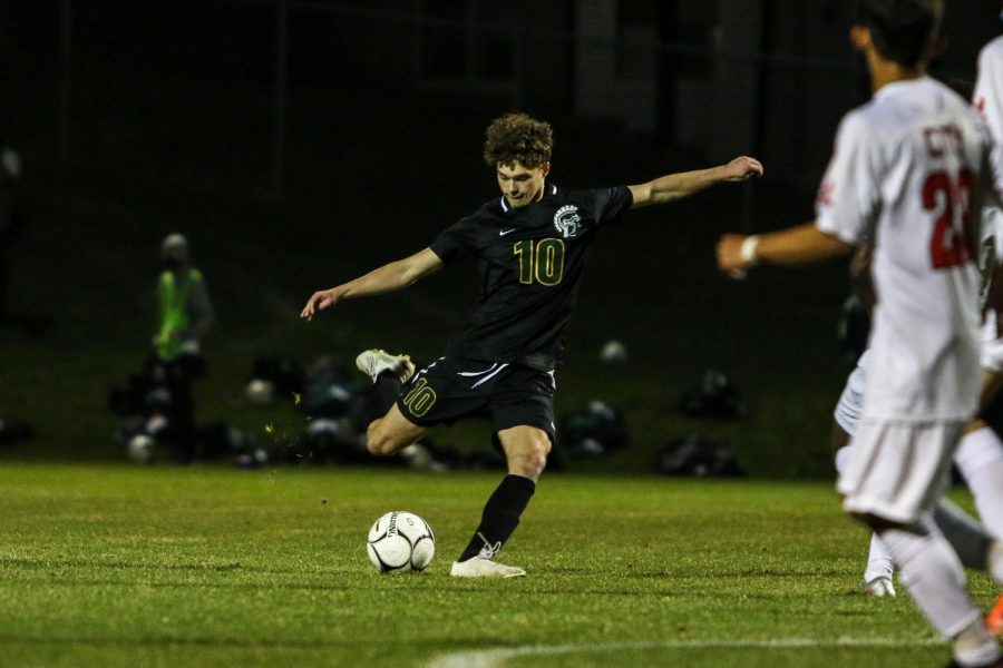 Owen Smith '21 takes a shot from the top of the box against City High at Ed Barker Field on April 23. 