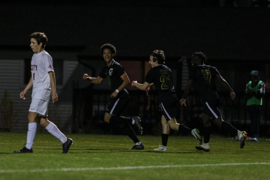 Kolby Godbolt '21 celebrates his late goal to put the Trojans up 3-1 against City High at Ed Barker Field on April 23. 