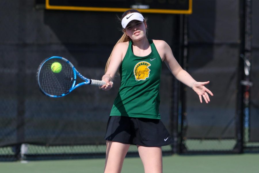 Ella De Young '23 defends her side of the court against City High at the Hawkeye Tennis and Recreation Center on April 29.