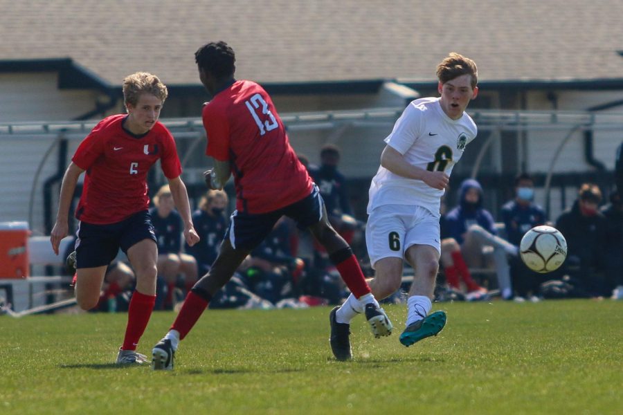 Luke Moenning '21 passes the ball ahead against Urbandale on April 3 during the Iowa City West Classic.