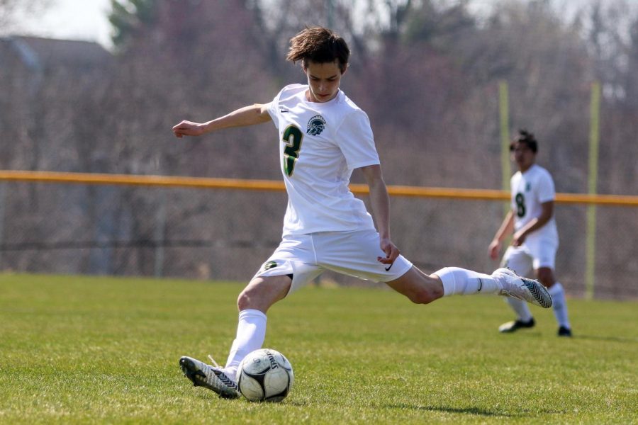 Matthew Steinbronn '21 clears the ball against Urbandale on April 3 during the Iowa City West Classic.