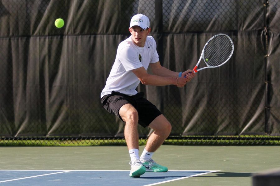 BJ Wolf '21 waits to backhand the ball to the other side of the court against City High at the Hawkeye Tennis and Recreation Center on April 29.