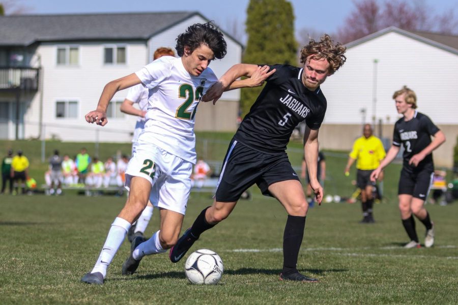 Teo Gonzalez '22 fights for possession against Ankeny Centennial on April 3 during the Iowa City West Classic.