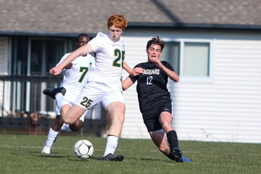 Charlie Miller '21 takes a shot from the top of the box against Ankeny Centennial on April 3 during the Iowa City West Classic.