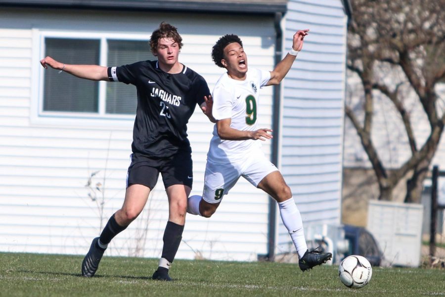 Kolby Godbolt '21 fights for position on a breakaway against Ankeny Centennial on April 3 during the Iowa City West Classic.