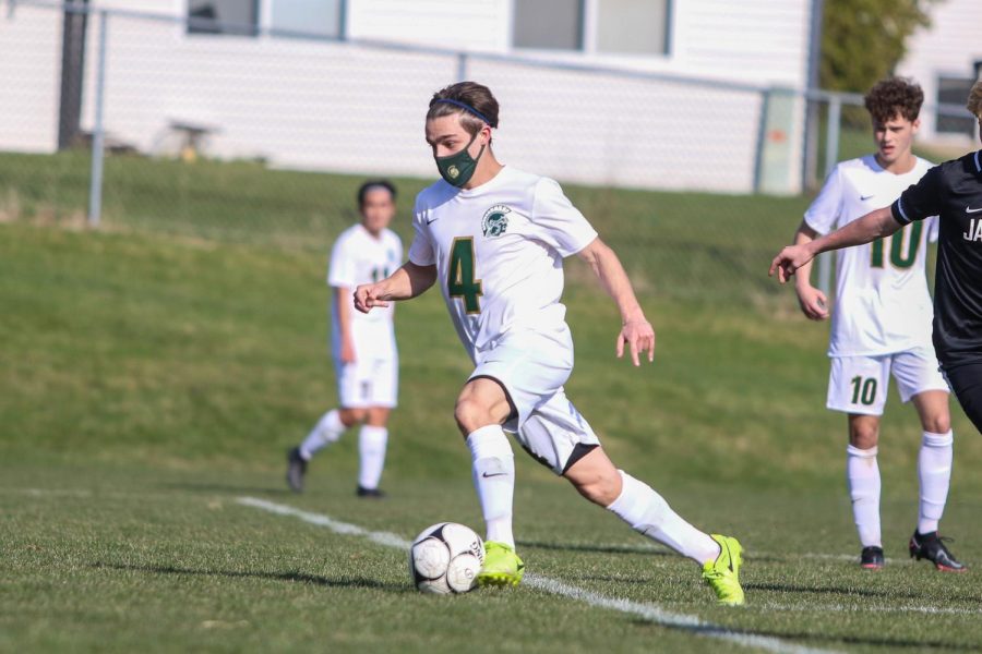 Miguel Cohen Suarez '22 looks to score after getting past his defender against Ankeny Centennial on April 3 during the Iowa City West Classic.