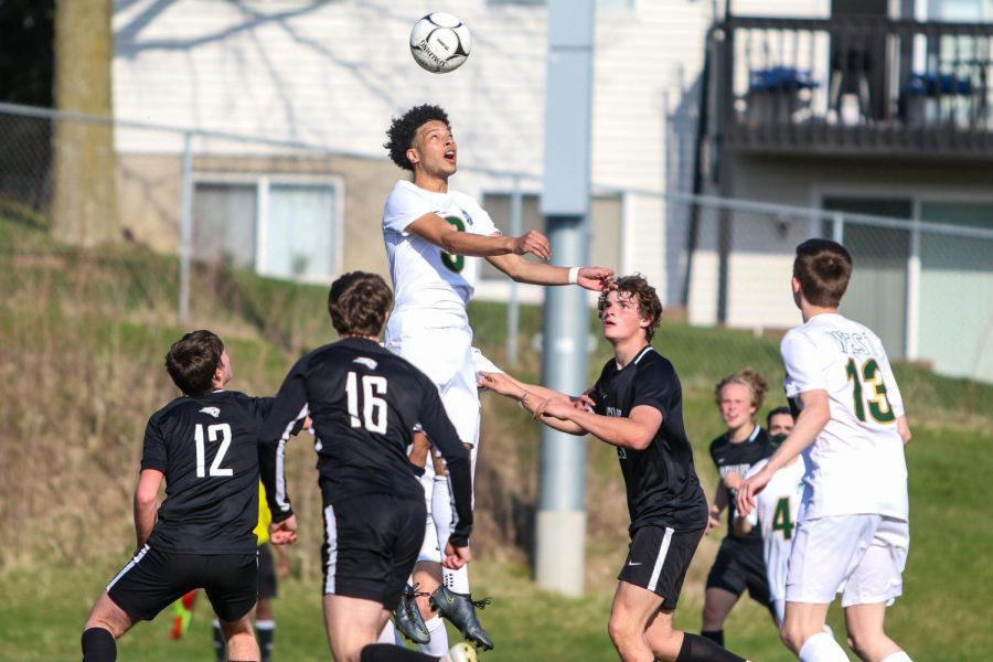 Kolby Godbolt '21 heads the ball into the air against Ankeny Centennial on April 3 during the Iowa City West Classic.