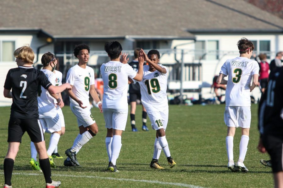 Andy Lu '21 celebrates after scoring a penalty kick against Ankeny Centennial on April 3 during the Iowa City West Classic.