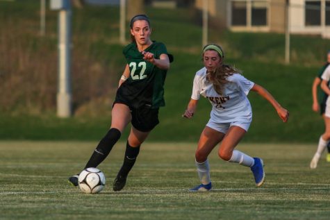 Makenna Vonderhaar 22 gets past her defender as she looks to pass against Ankeny on April 6.