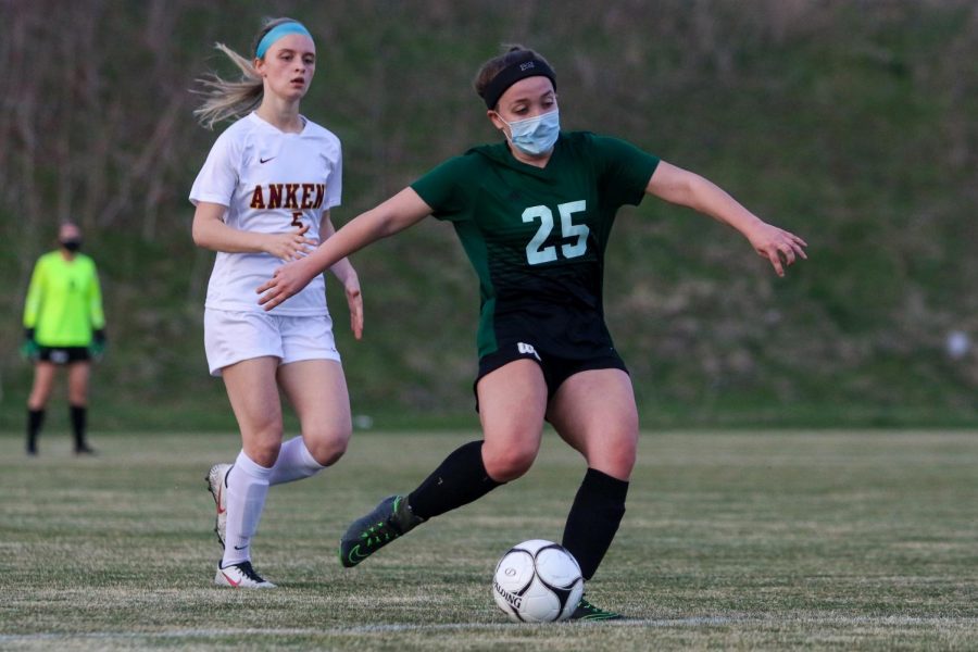 Anna Verry '22 clears the ball against Ankeny on April 6.