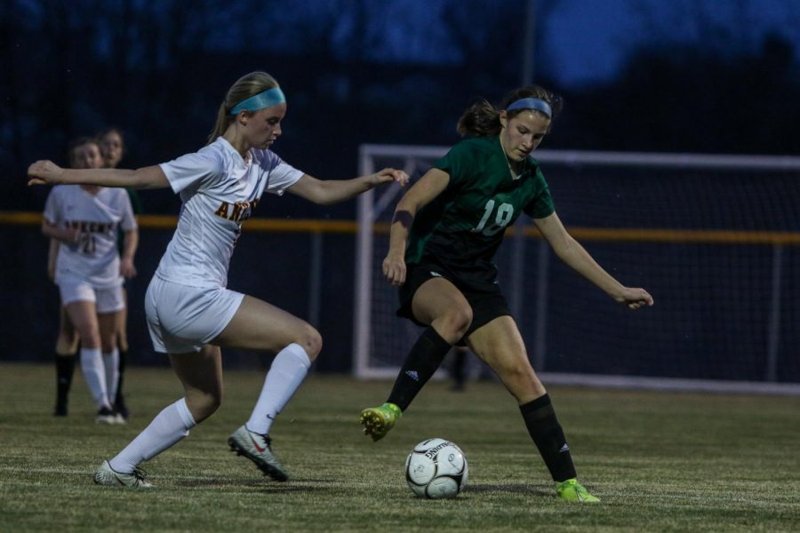 Ally Skala '24 fights for possession against Ankeny on April 6.