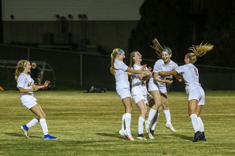 Ankeny celebrates their win in penalty kicks after defeating the Trojans in their first game of the season on April 6.