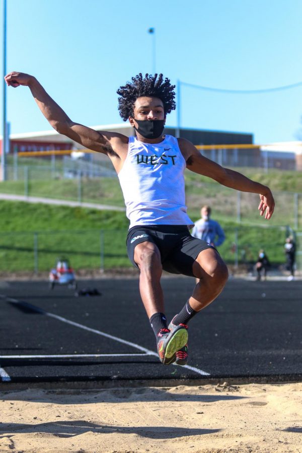 Daquan Johnson '21 long jumps during the Eastern Iowa Track and Field Festival on April 12.