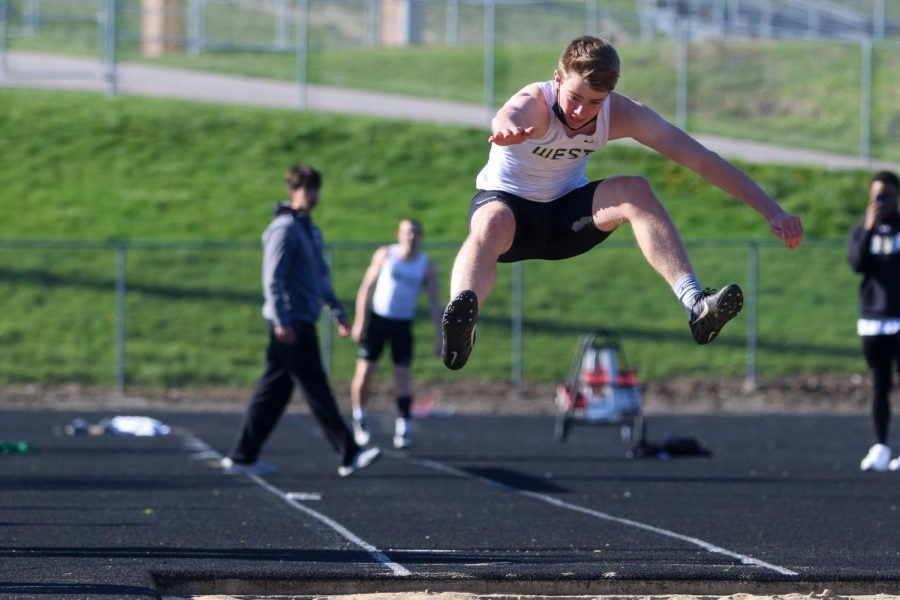 Aidan Jacobsen '24 strides out while long jumping during the Eastern Iowa Track and Field Festival on April 12.