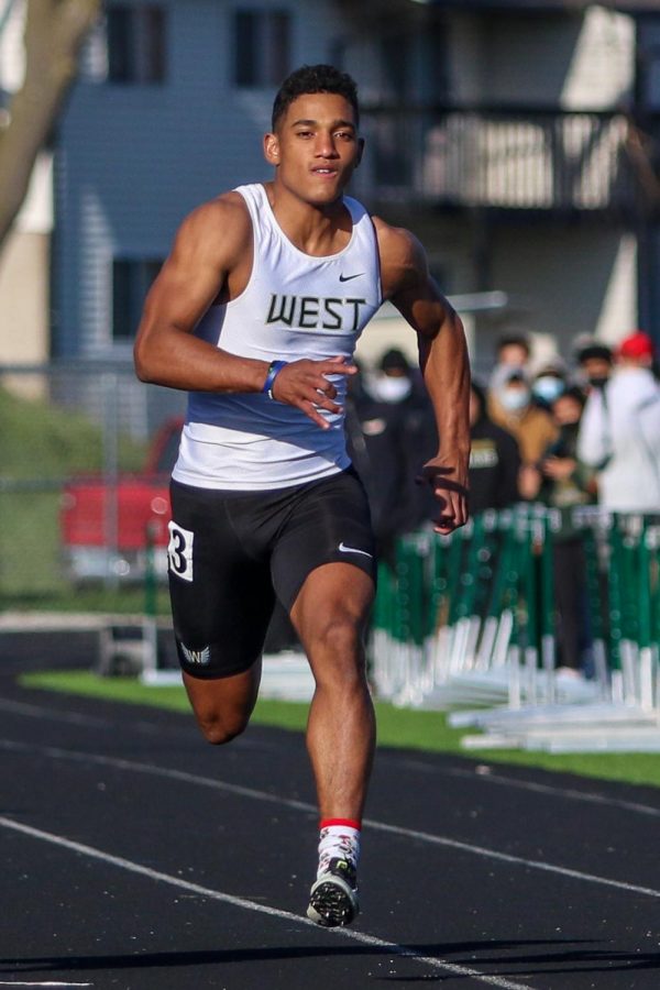 Mason Applegate '22 finishes strong in the 100 meter dash during the Eastern Iowa Track and Field Festival on April 12.