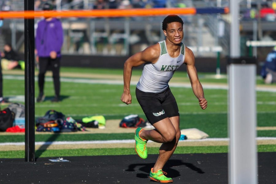 Daniel Robinson '24 runs up to the bar as he prepares to jump during the Eastern Iowa Track and Field Festival on April 12.